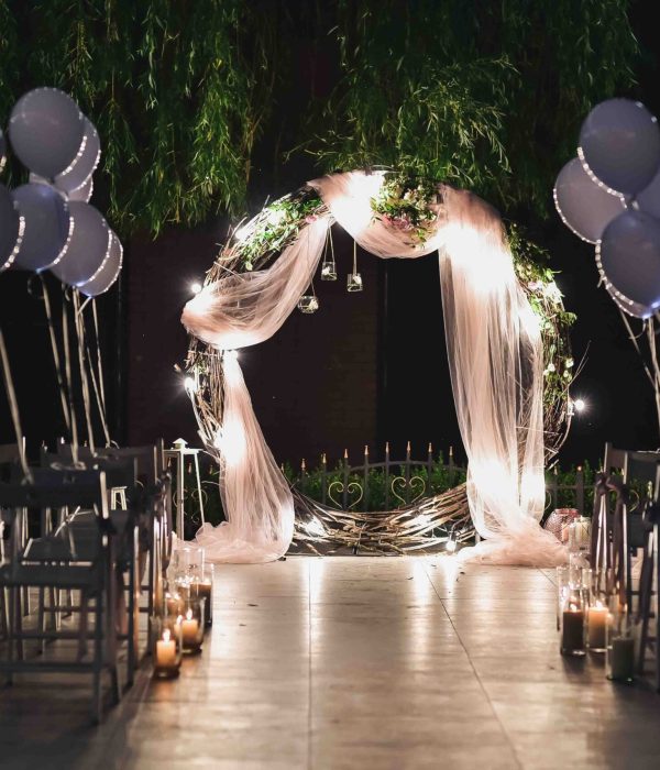 Shine wedding altar for newlyweds stands on the backyard decorated with balloons and greenery
